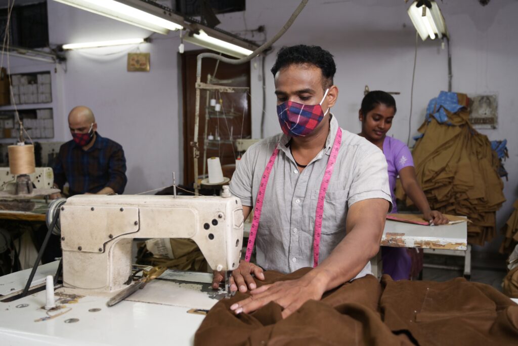 Man,Is,Sewing,Clothes,Using,Sewing,Machine,In,Textile,Factory