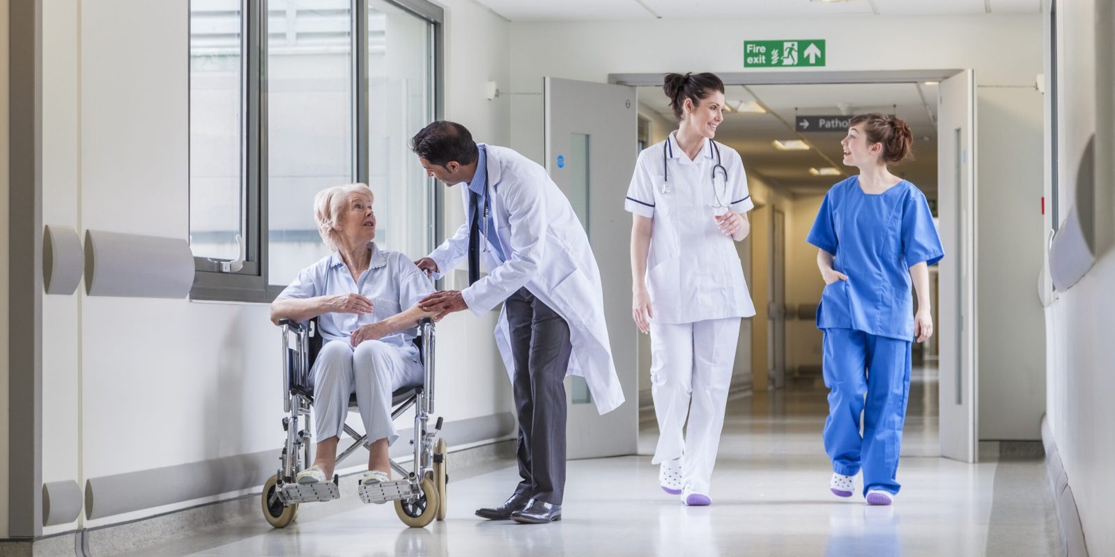 Senior,Female,Woman,Patient,In,Wheelchair,Sitting,In,Hospital,Corridor